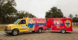 Two Harrell & King trucks parked in a parking lot